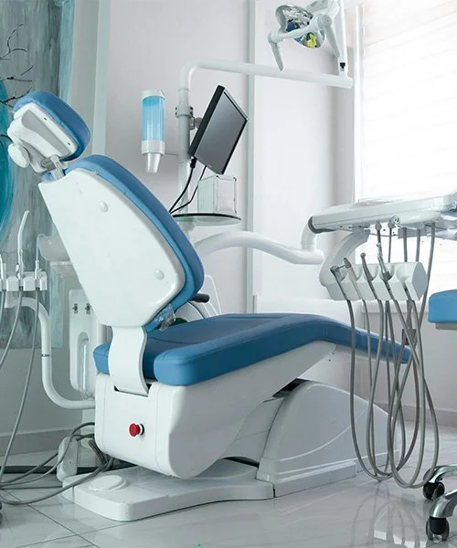 Dental chair in a dental office with various dental tools and equipment