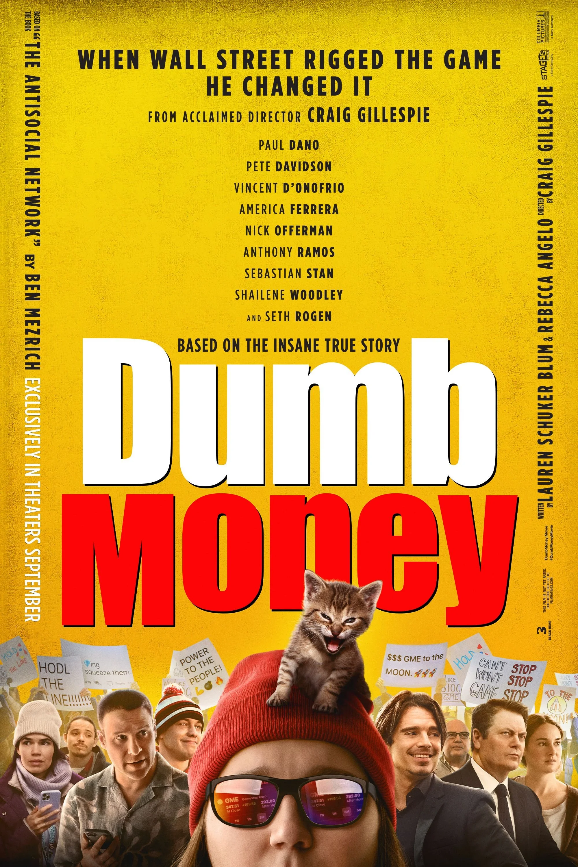 The poster for the movie "Dumb Money" featuring a crowd of protesters, a woman wearing red glasses and a red beanie with a kitten on her head, and various protest signs in the background. The film is based on the true story of Wall Street's GameStop stock frenzy.