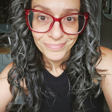 Heather E. Coleman wearing red glasses