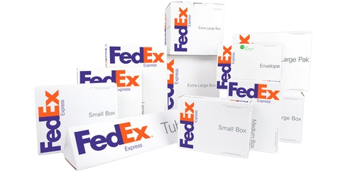 Multiple FedEx shipping boxes of various sizes stacked together.