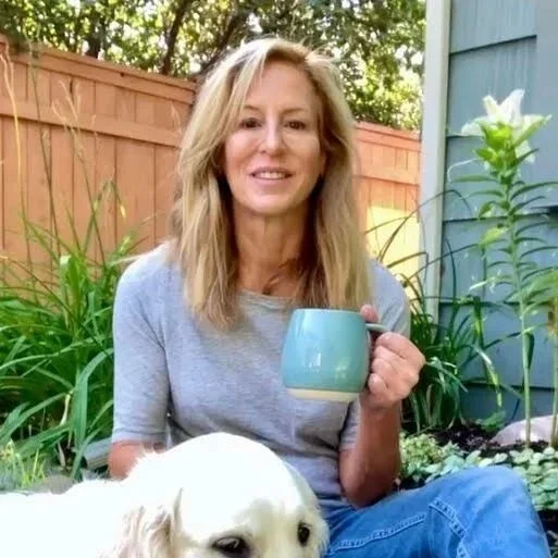 Leanne Young outdoors holding a mug of tea