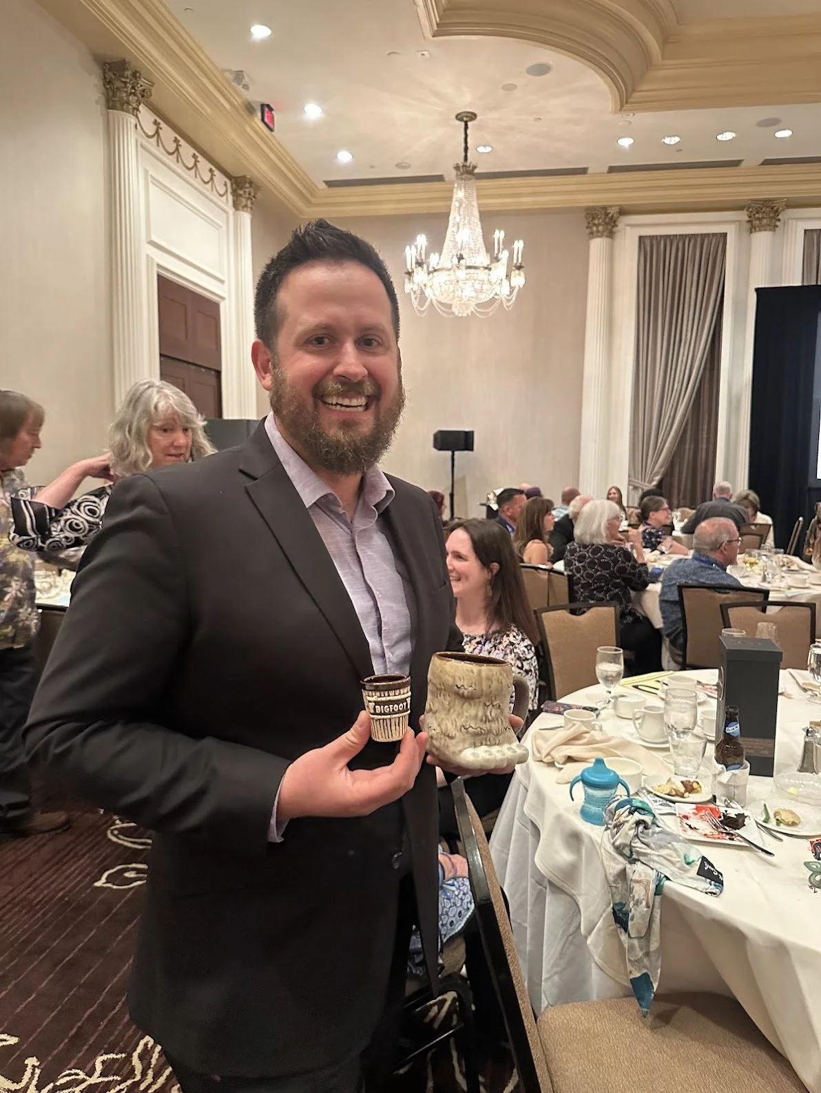 Photo of Aaron Klesick holding a coffee cup