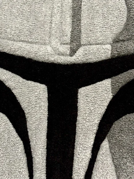 Close-up of a black and gray patterned carpet with abstract design.