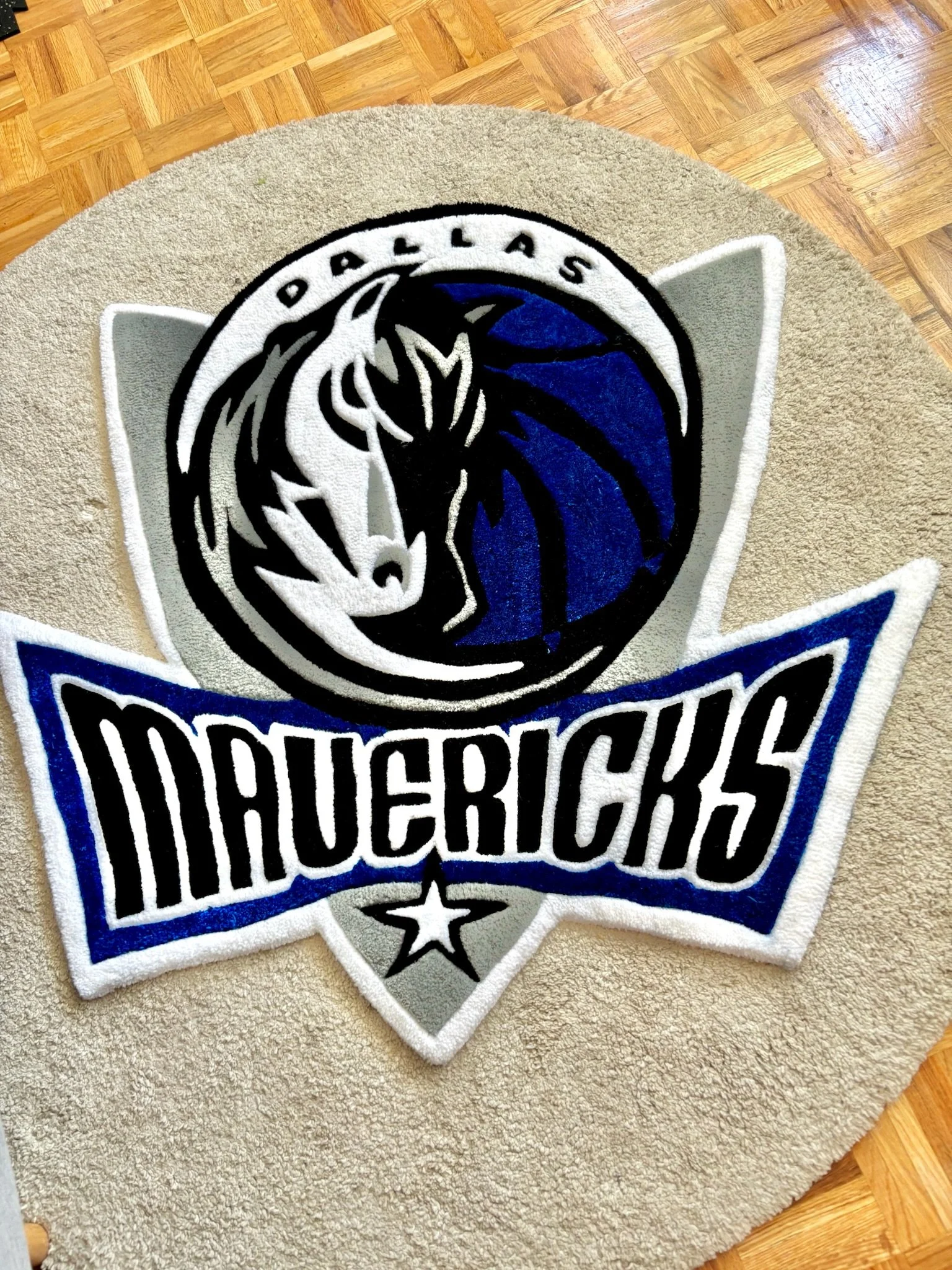 Dallas Stars NHL team logo embroidered on a beige circular mat placed on a wooden floor.