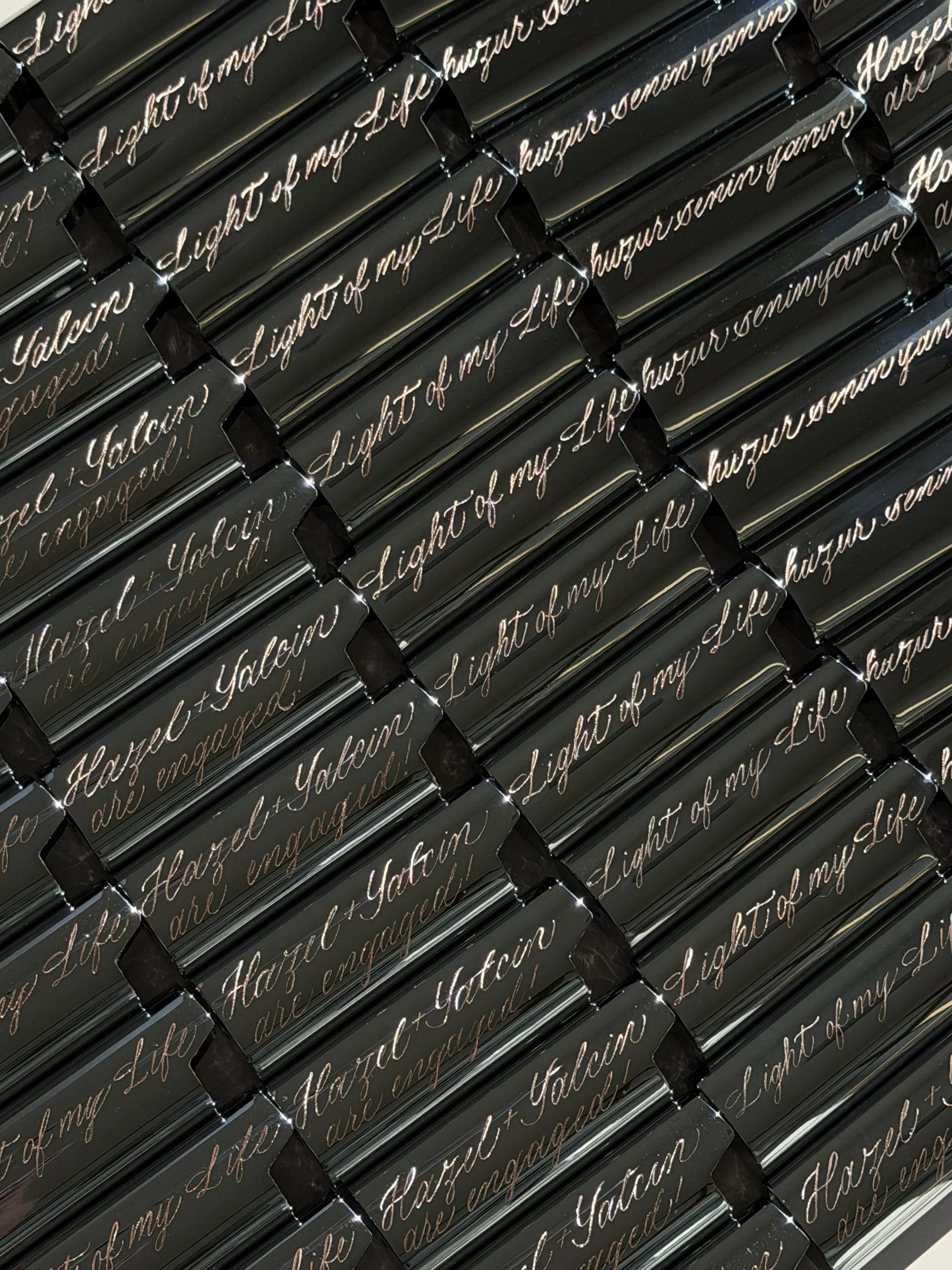 Custom engraved lighter cases with gold cursive lettering for Hazel and Yalcin’s engagement party.