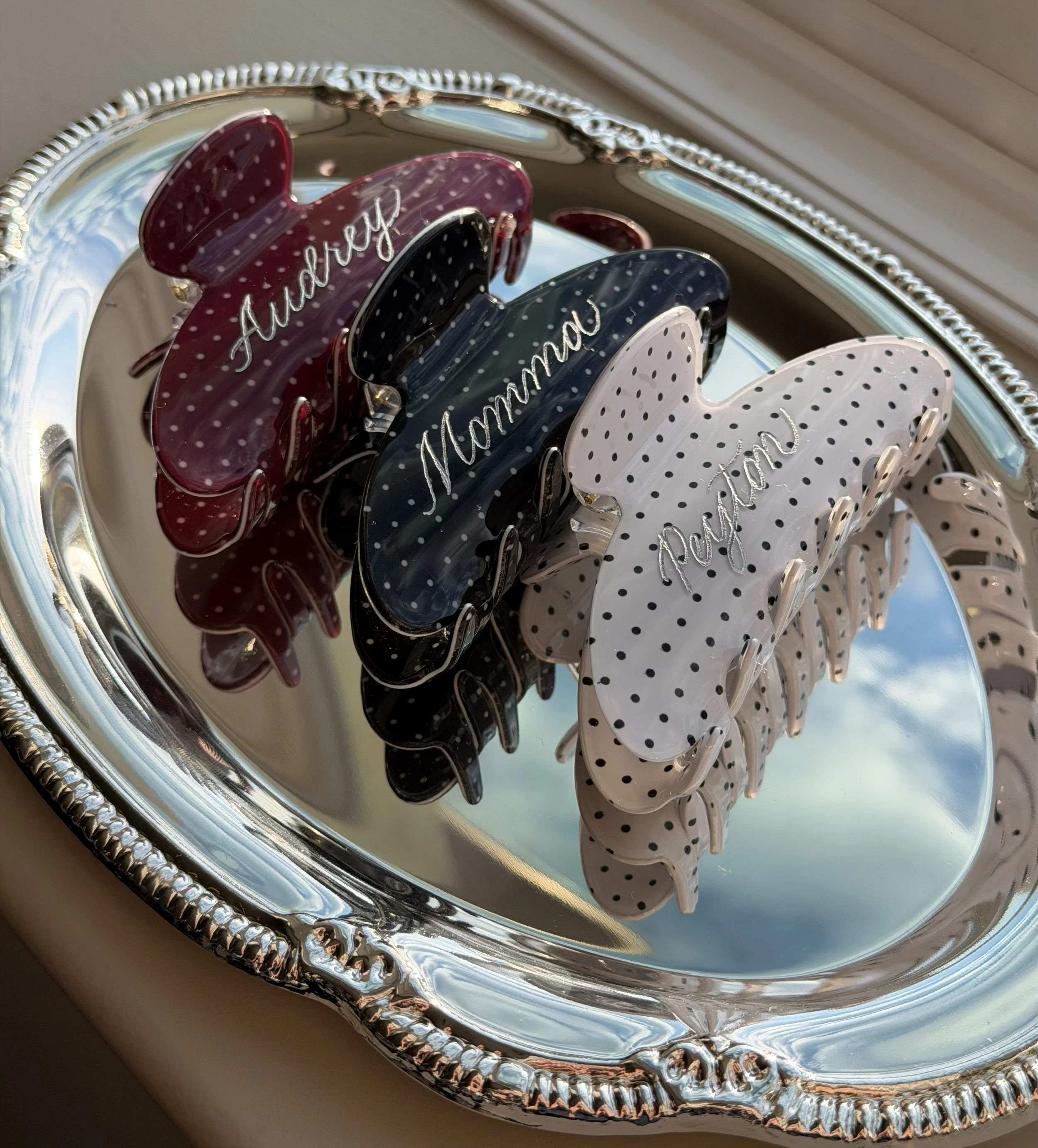 Claw clips personalized with individual names in custom lettering.