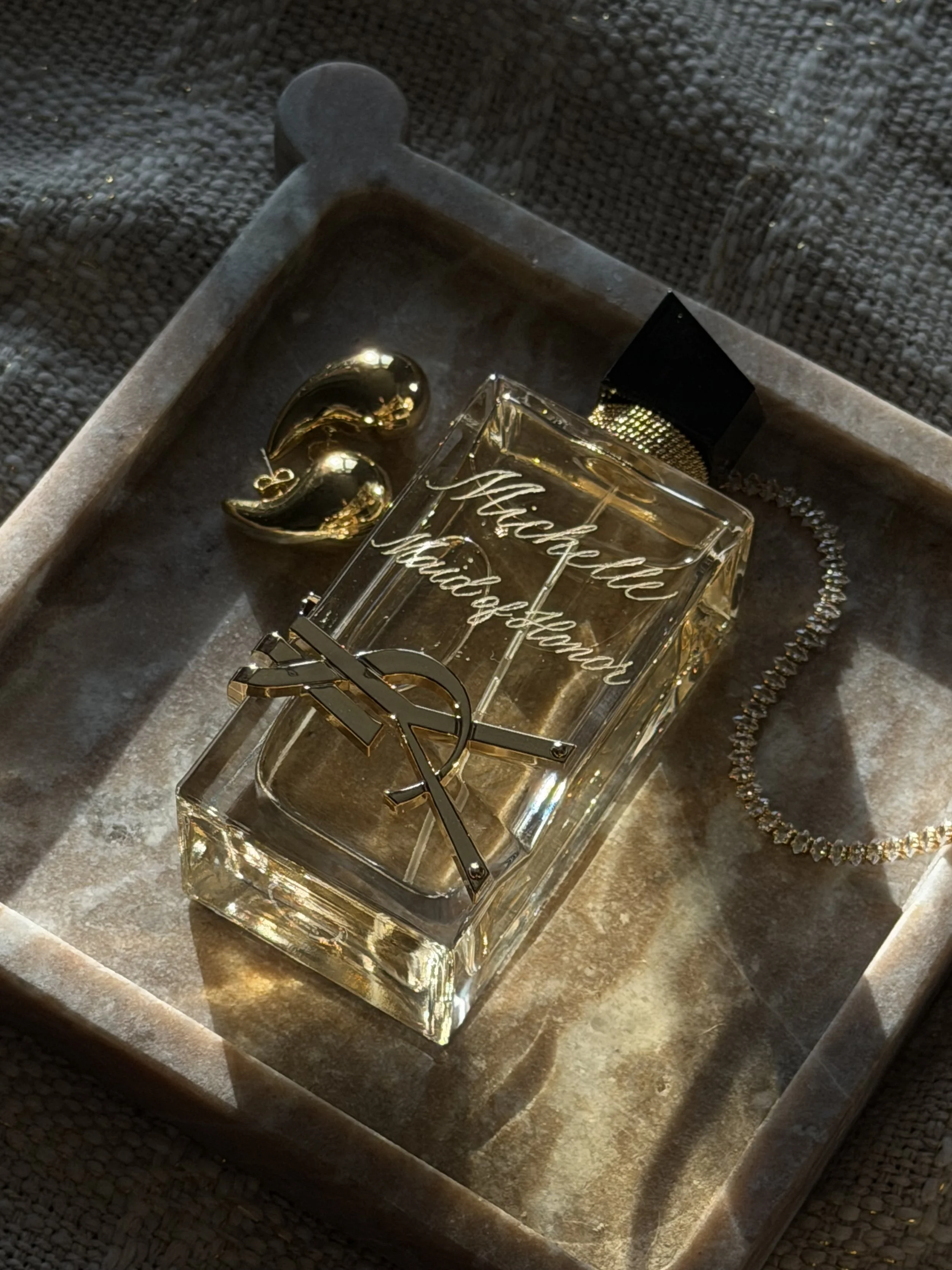 Hand engraved Yves Saint Laurent fragrance bottle personalized with custom calligraphy.