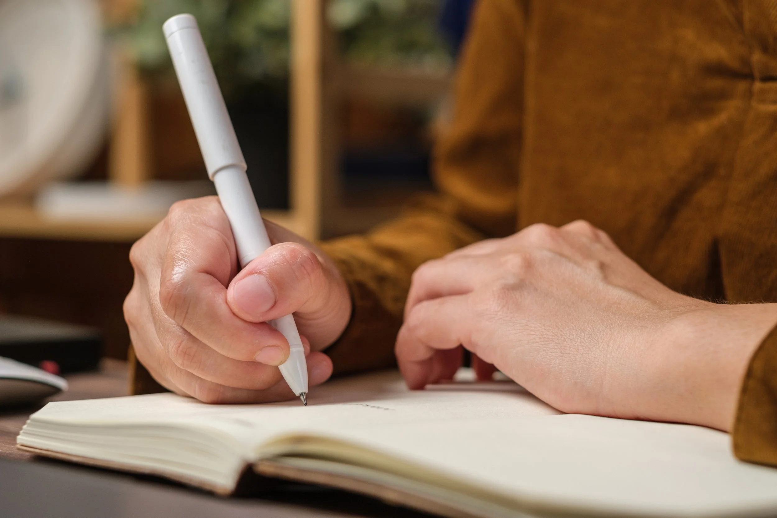 Close up of a woman's hand writing