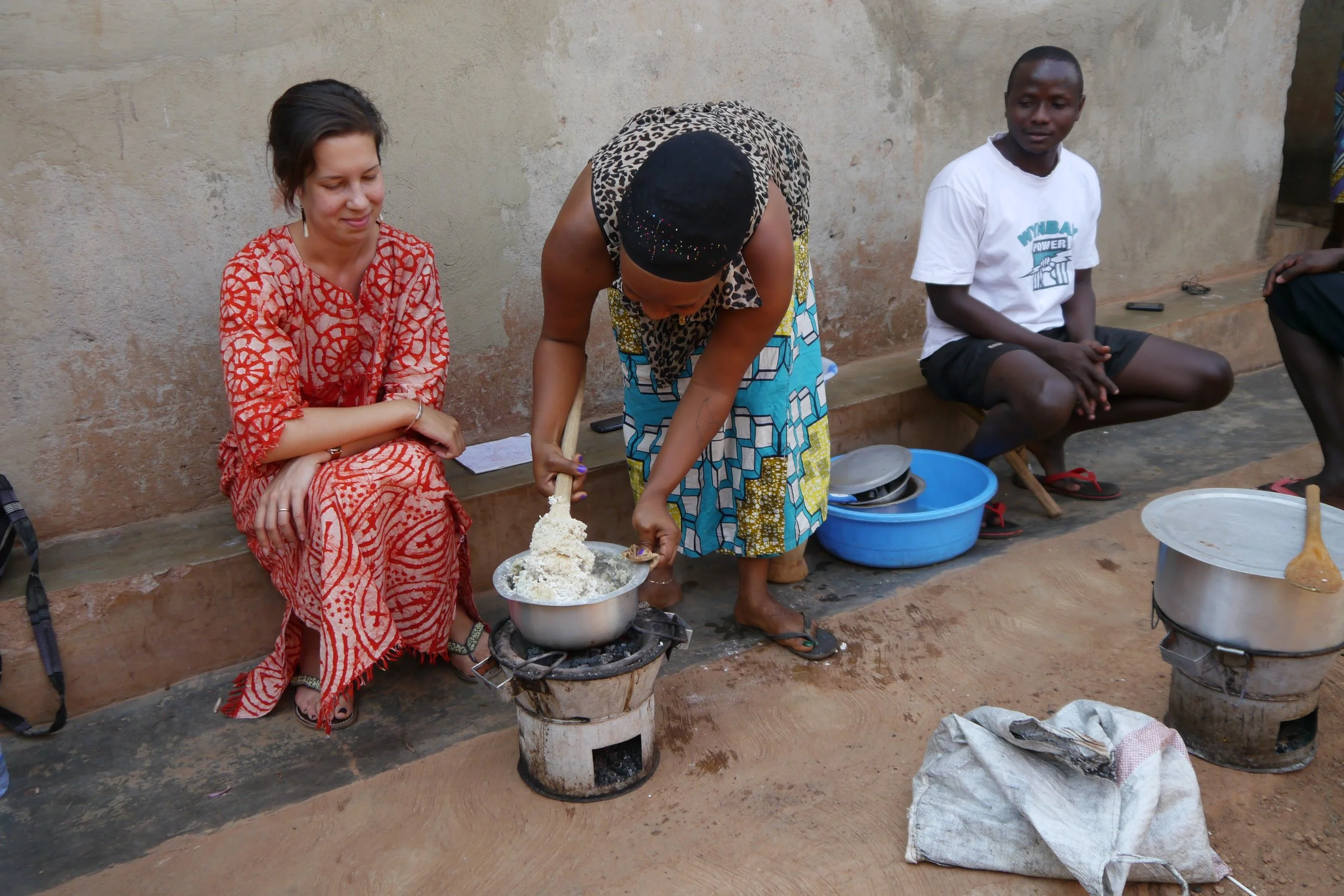 Carla watching a woman make food in the Congo