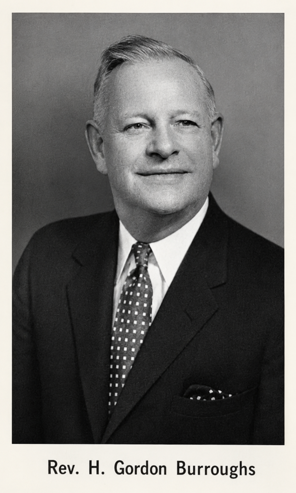 Black and white portrait of Rev. H. Gordon Burroughs wearing a suit, tie, and pocket square.
