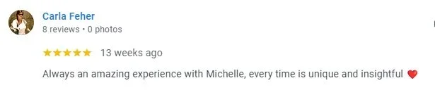 User review from Carla Feher praising her experience with Michelle, mentioning each experience is unique and insightful, accompanied by a heart emoji.
