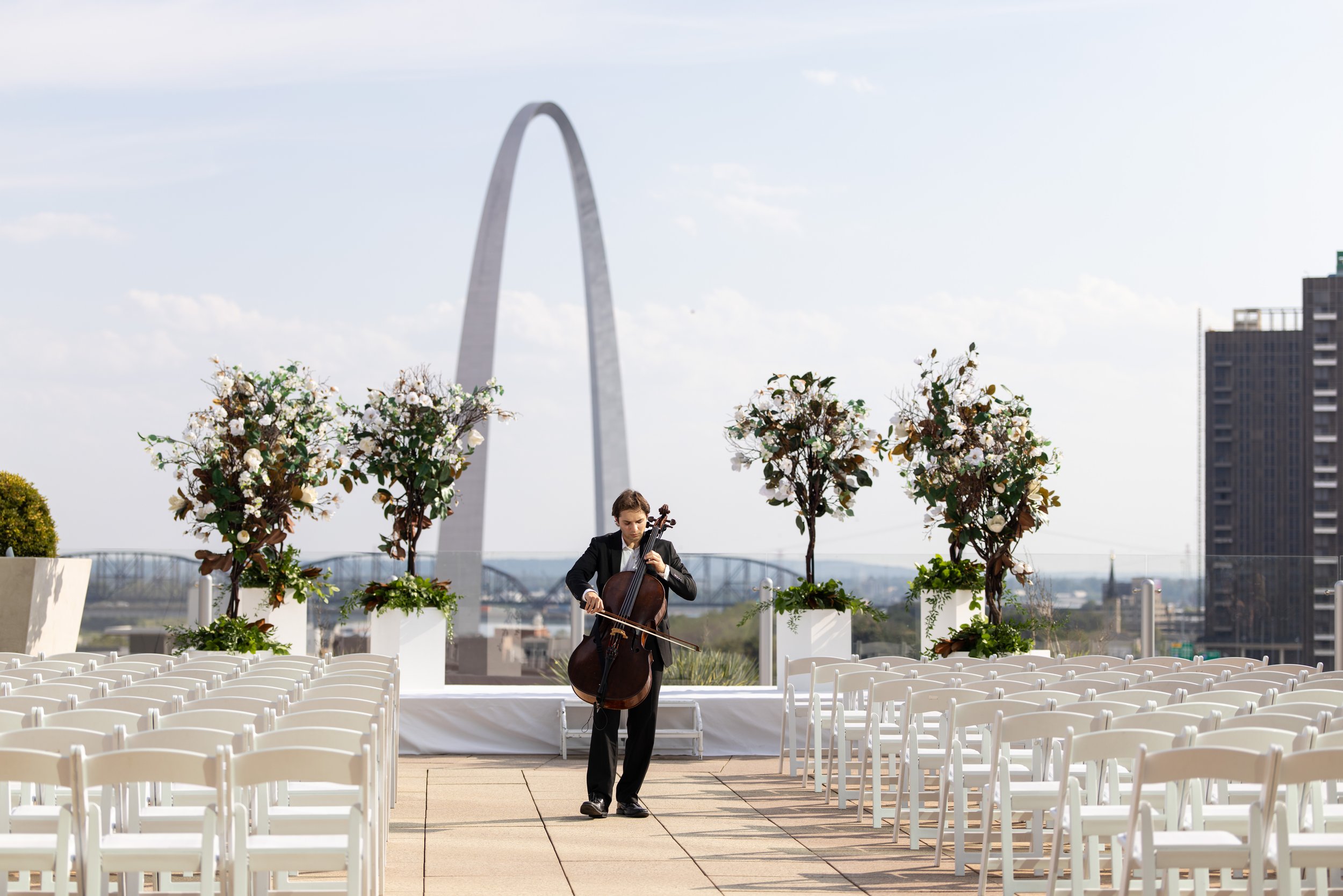 Daniel Diringer, Cellist for Weddings & Events, playing cello at an outdoor wedding ceremony at the 4 Seasons in St. Louis
