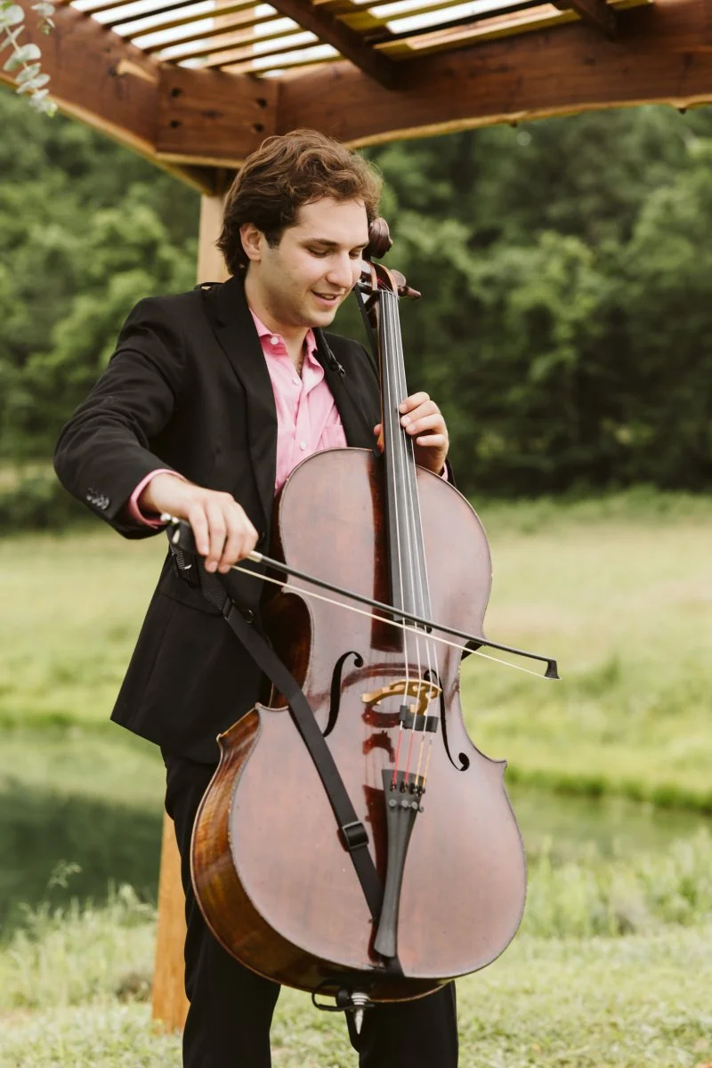 Close-up of a wedding cellist in formal attire providing elegant live music for a wedding ceremony in St. Louis.