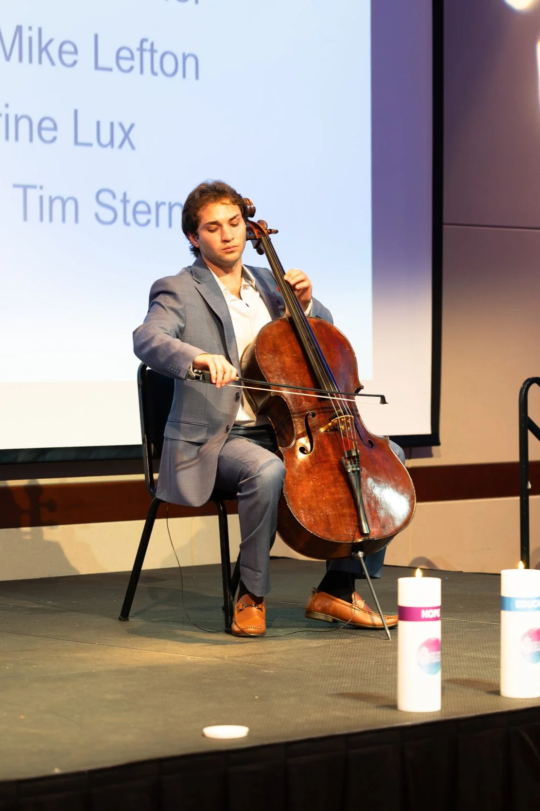 St. Louis Wedding & Event cellist performing on stage at a corporate event in St. Louis