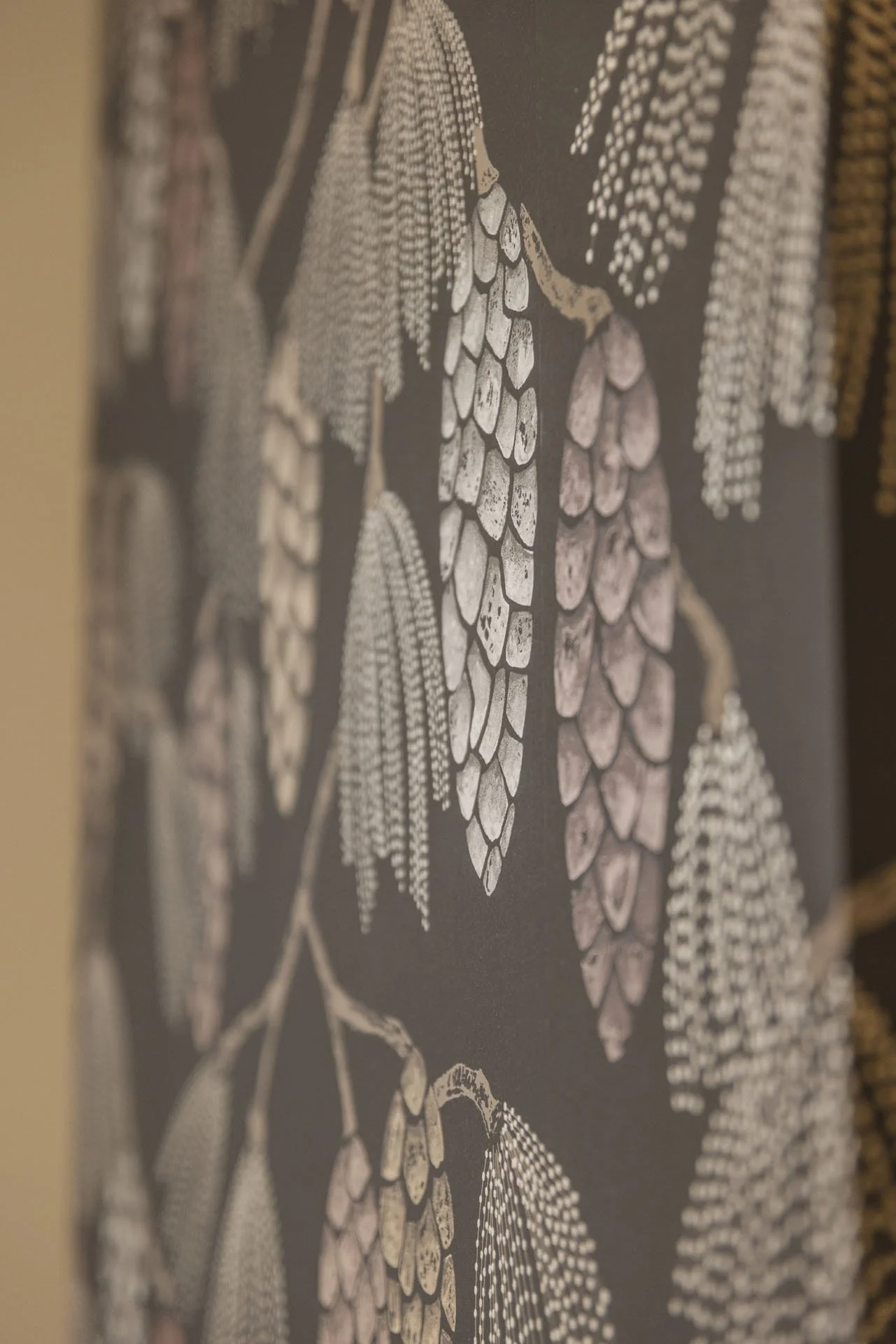 Close-up of a floral patterned fabric with white and pink flowers on a dark background.