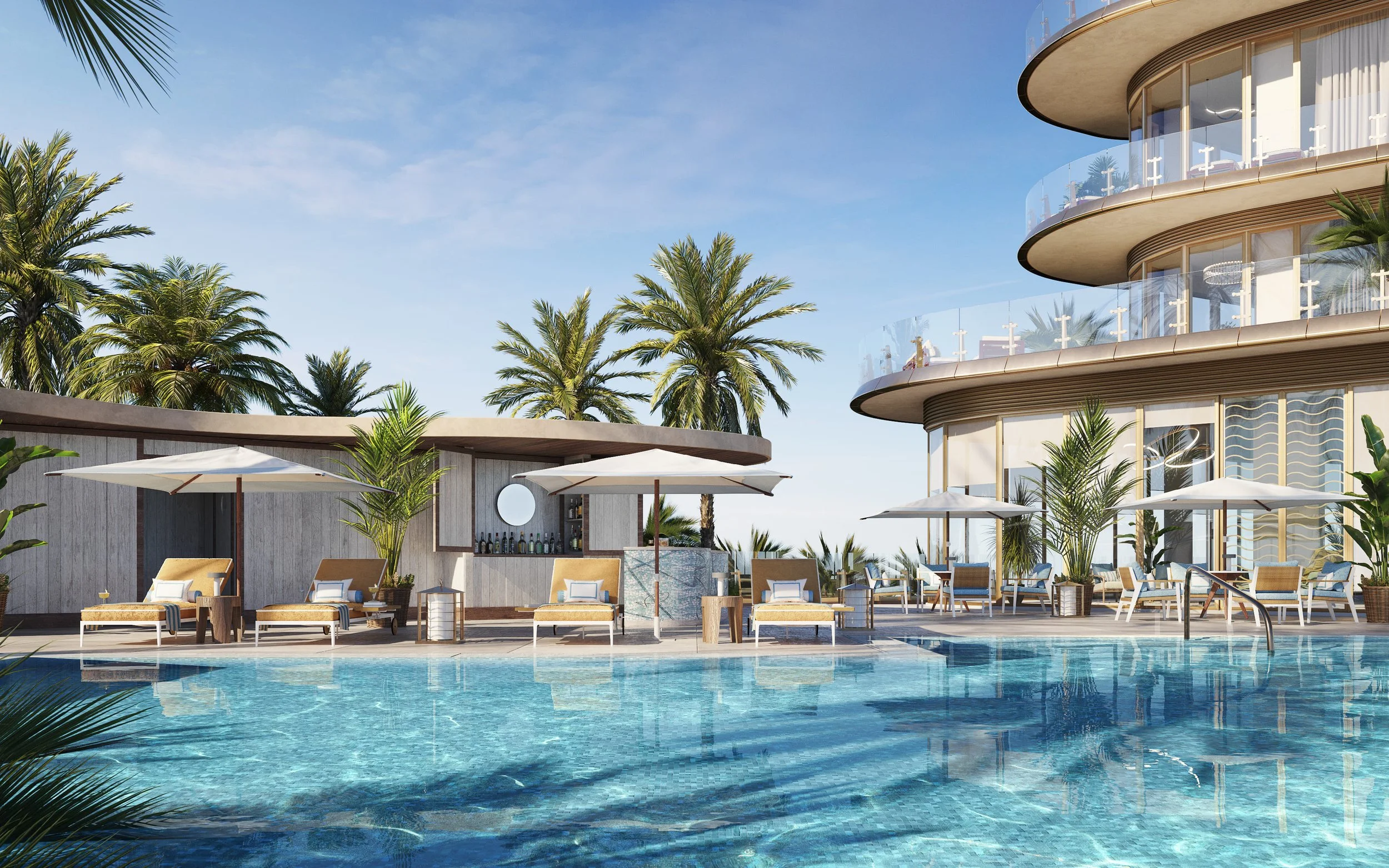 Luxury poolside area with lounge chairs, umbrellas, and a modern building with curved balconies in a tropical setting with palm trees.