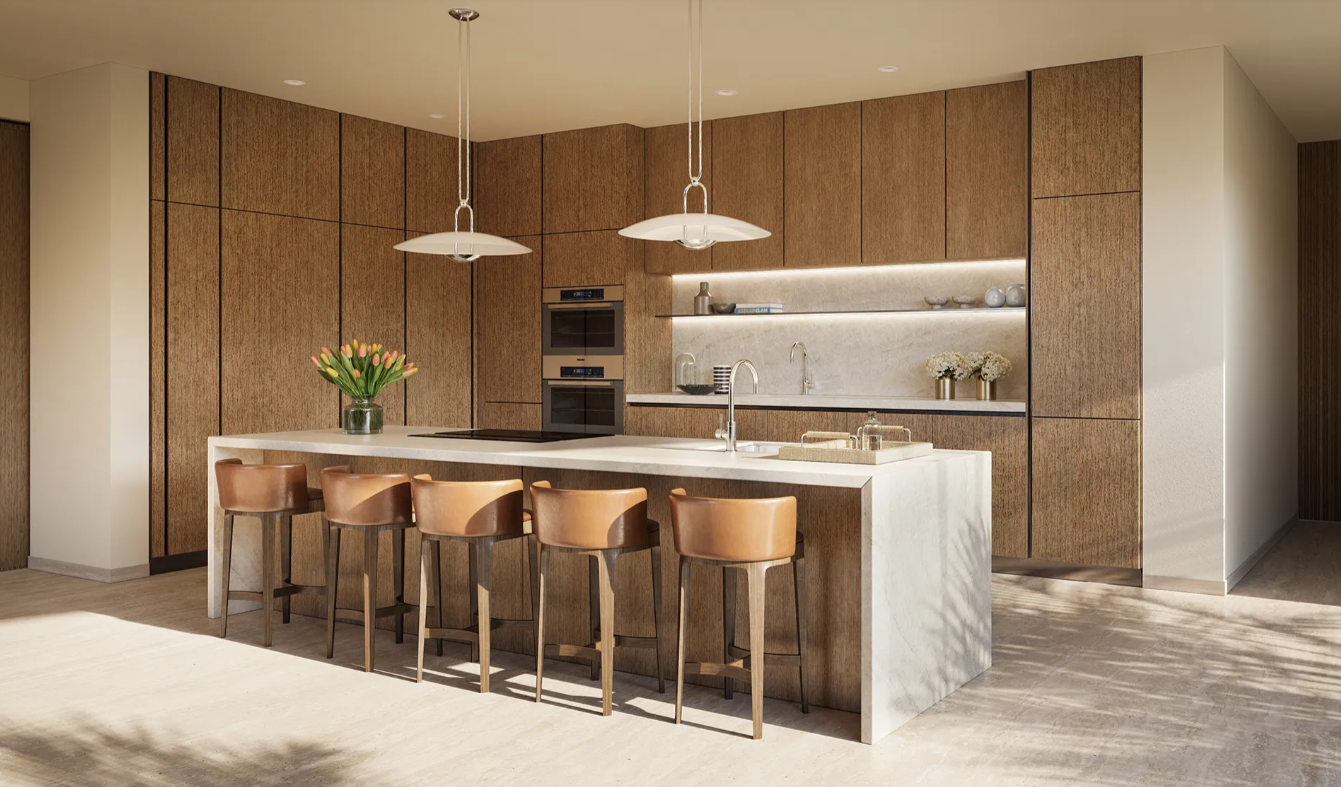 Modern kitchen with a white island, wooden cabinets, two pendant lights, a vase of pink tulips, and bar stools with leather seats.