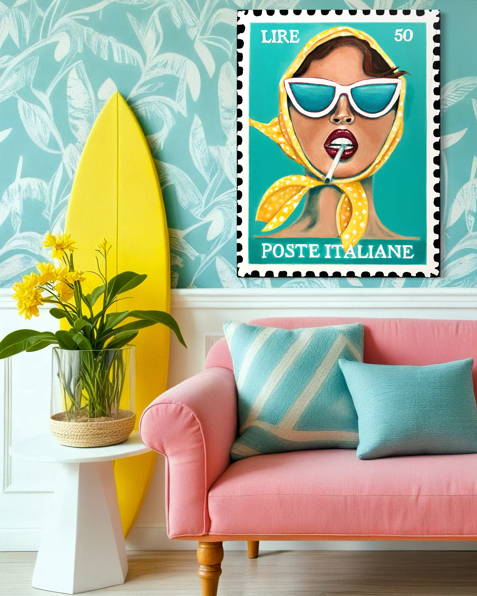 Pink sofa with a blue and white striped pillow in a living room with a white side table holding a clear glass vase with yellow flowers, a yellow surfboard leaning against the wall, and a colorful illustrated postage stamp-style portrait of a woman we