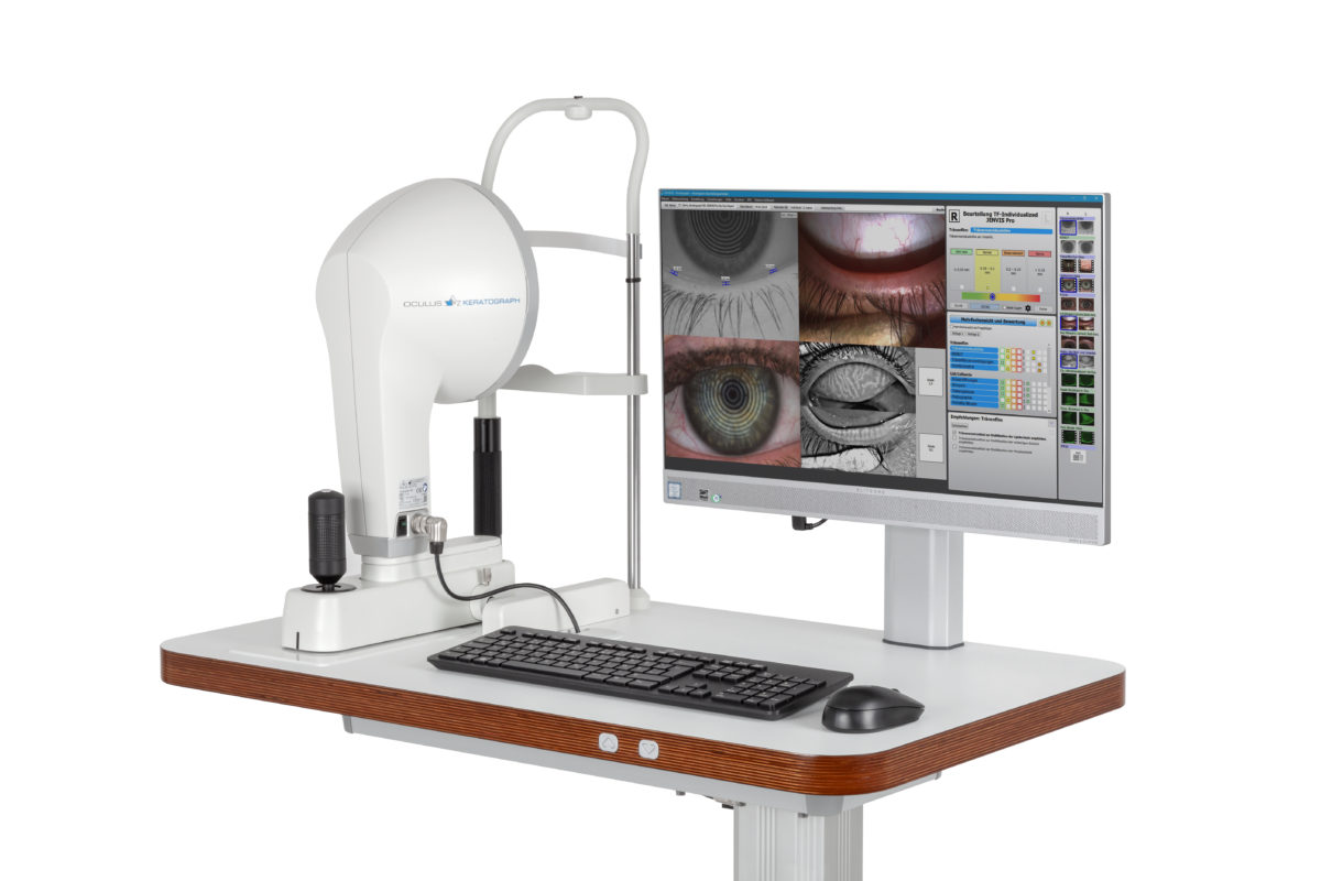 Eye examination equipment with a monitor displaying images of eyes and detailed eye measurements.