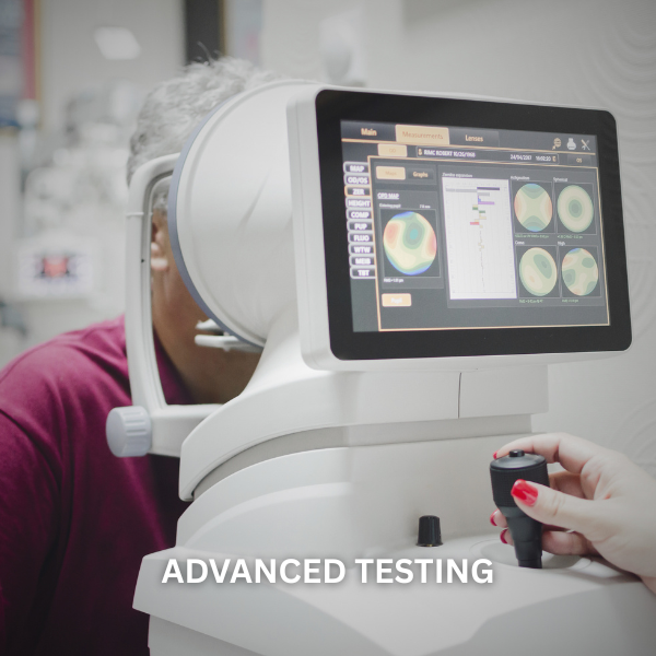 An elderly woman undergoing eye testing with an advanced ophthalmic device that displays colorful eye images and measurements on a digital screen.