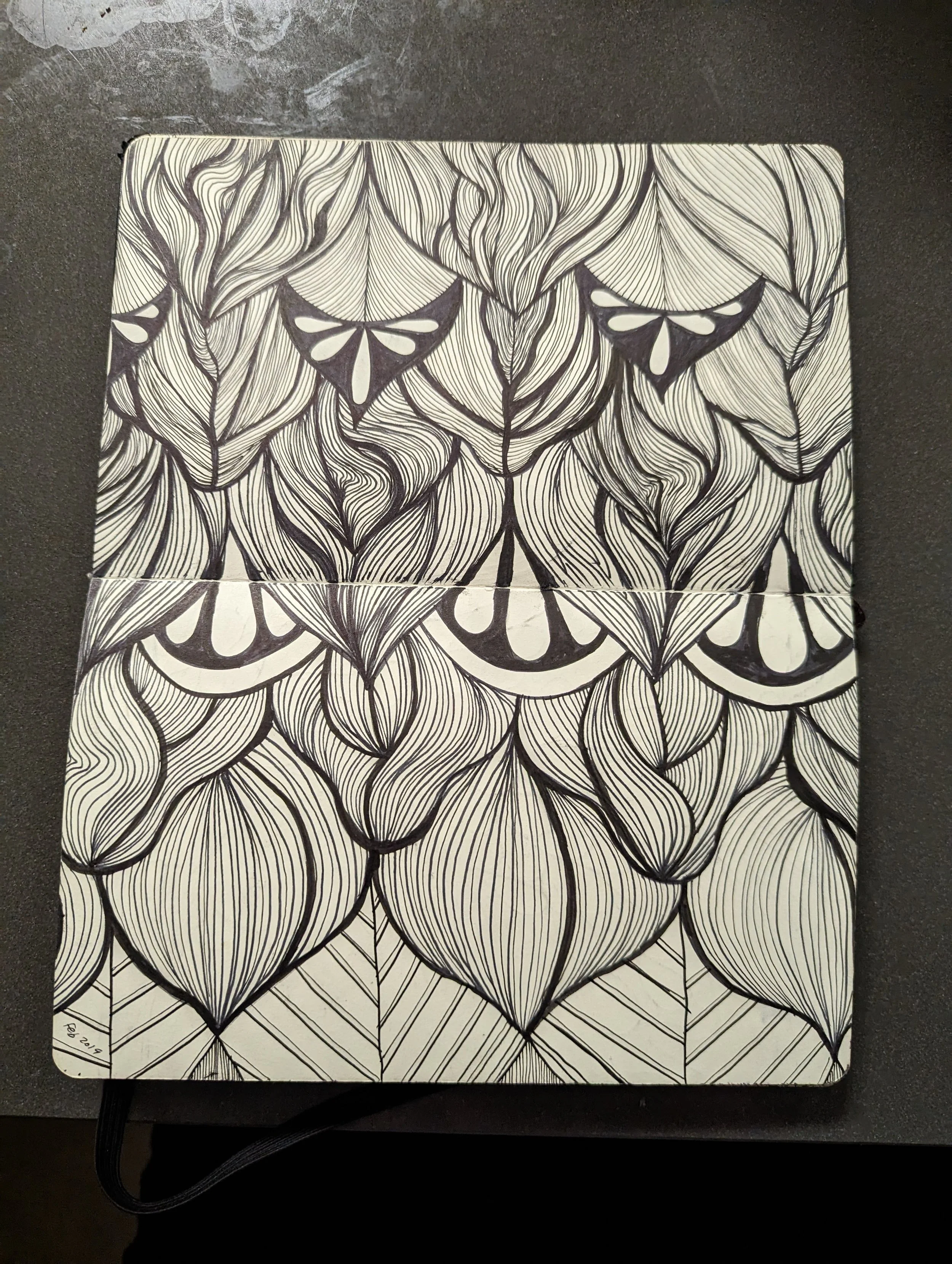 A black and white abstract drawing with patterns resembling leaves, petals, and butterfly shapes.