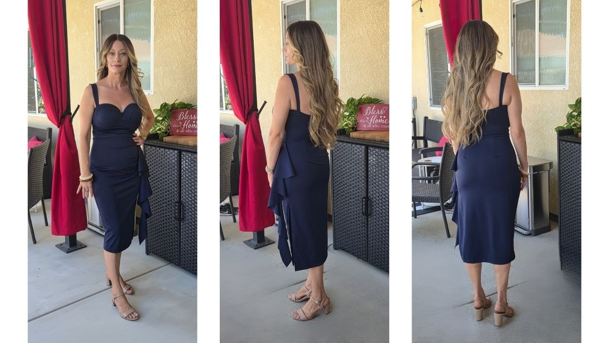 Woman wearing an affordable navy blue wedding guest dress with ruching and heels