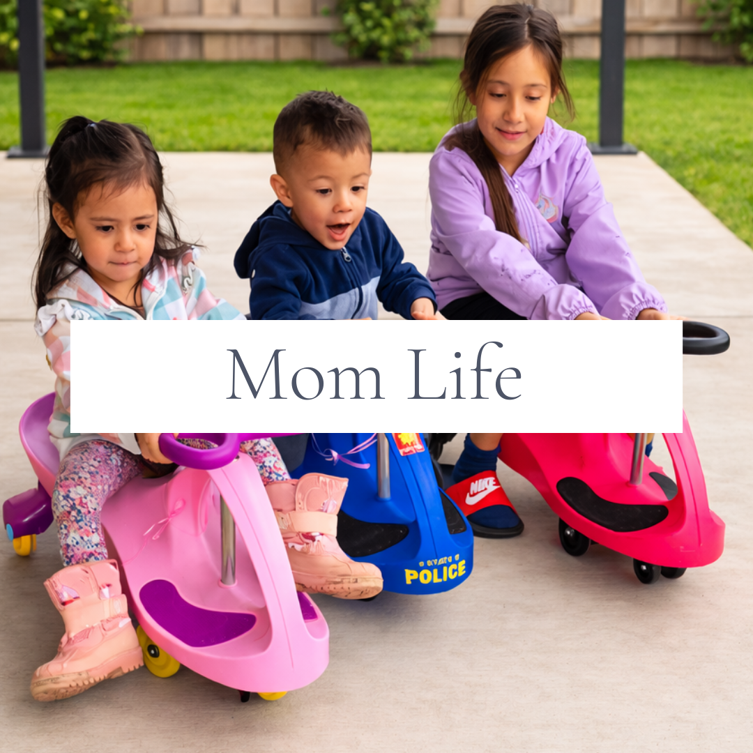 Three children riding Wiggle Cars together, representing mom life, family activities, parenting, and everyday moments with kids.