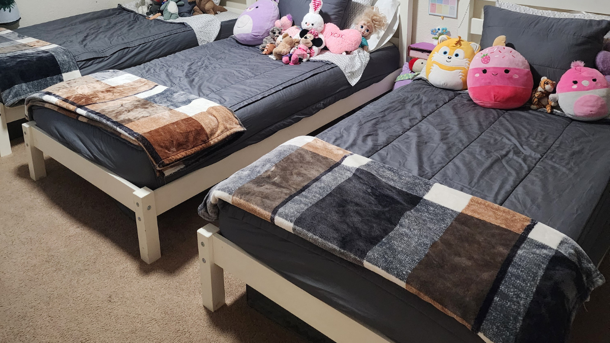 kids shared bedroom with three beds in a row no bunk beds layout for multiple kids