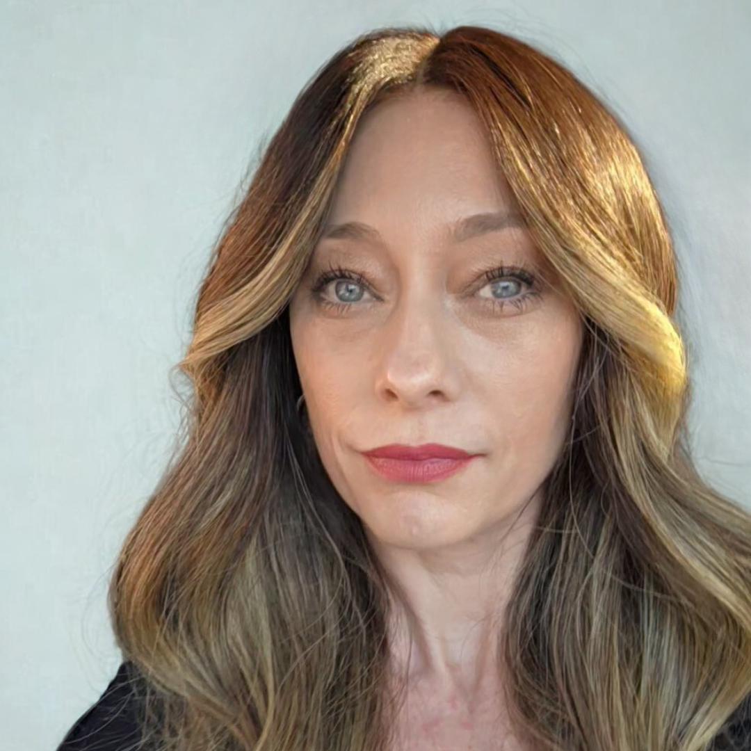 Mom lifestyle blogger workspace with laptop, pink florals, and Becky Kay Sixtos headshot