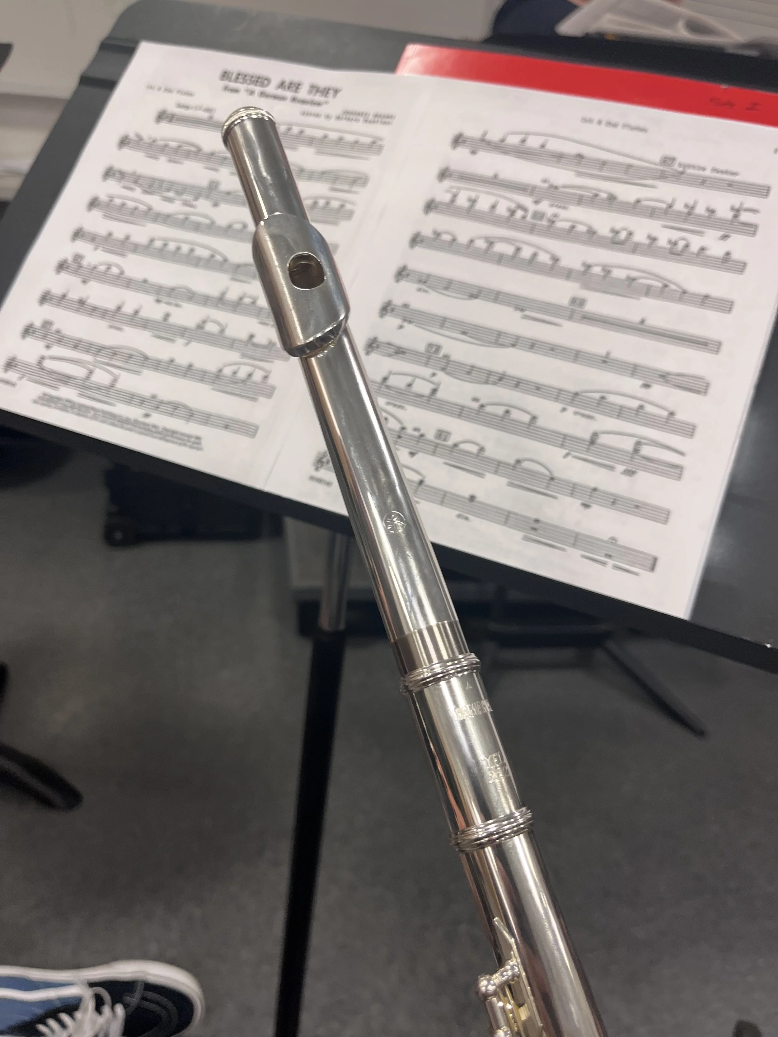A picture of Ari warming up with his flute during a CSUB & BC Orchestra practice