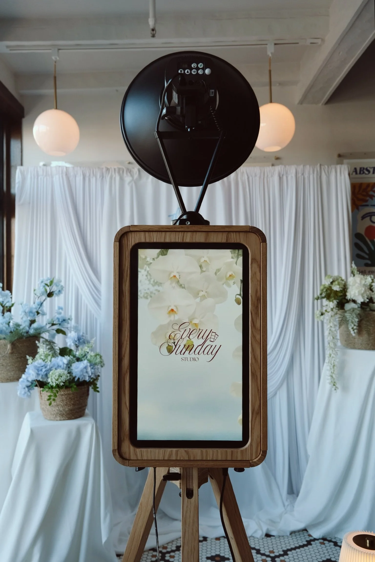 Every Sunday Studio luxury wooden photo booth with custom floral backdrop and branded overlay — Long Island wedding photo booth rental