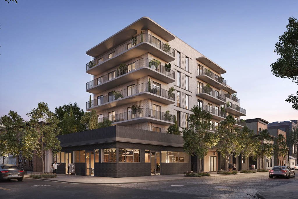 A modern, multi-story residential building with balconies and greenery, situated on a city street with cars and trees.