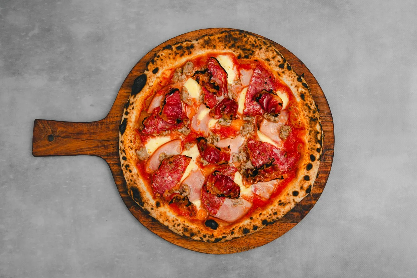 Vesuvio 
- Sauce, Fior Di Latte, Ham, Salami, Mild Pork & Fennel Sausage, Pancetta, Herb Oil 