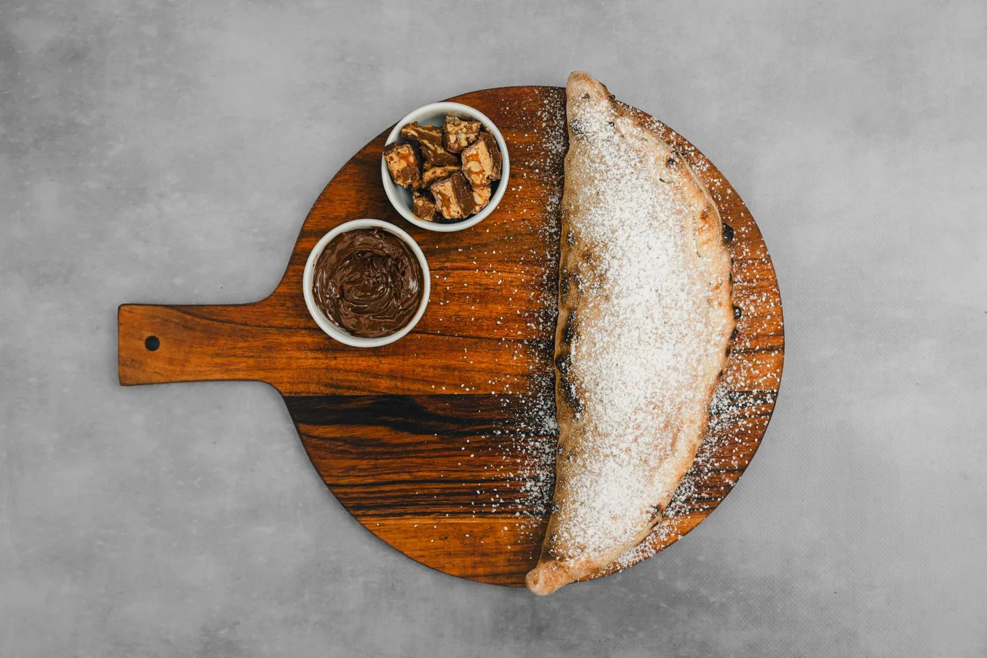 Snickers Calzone 
- Nutella, Snickers Chocolate, Icing Sugar 