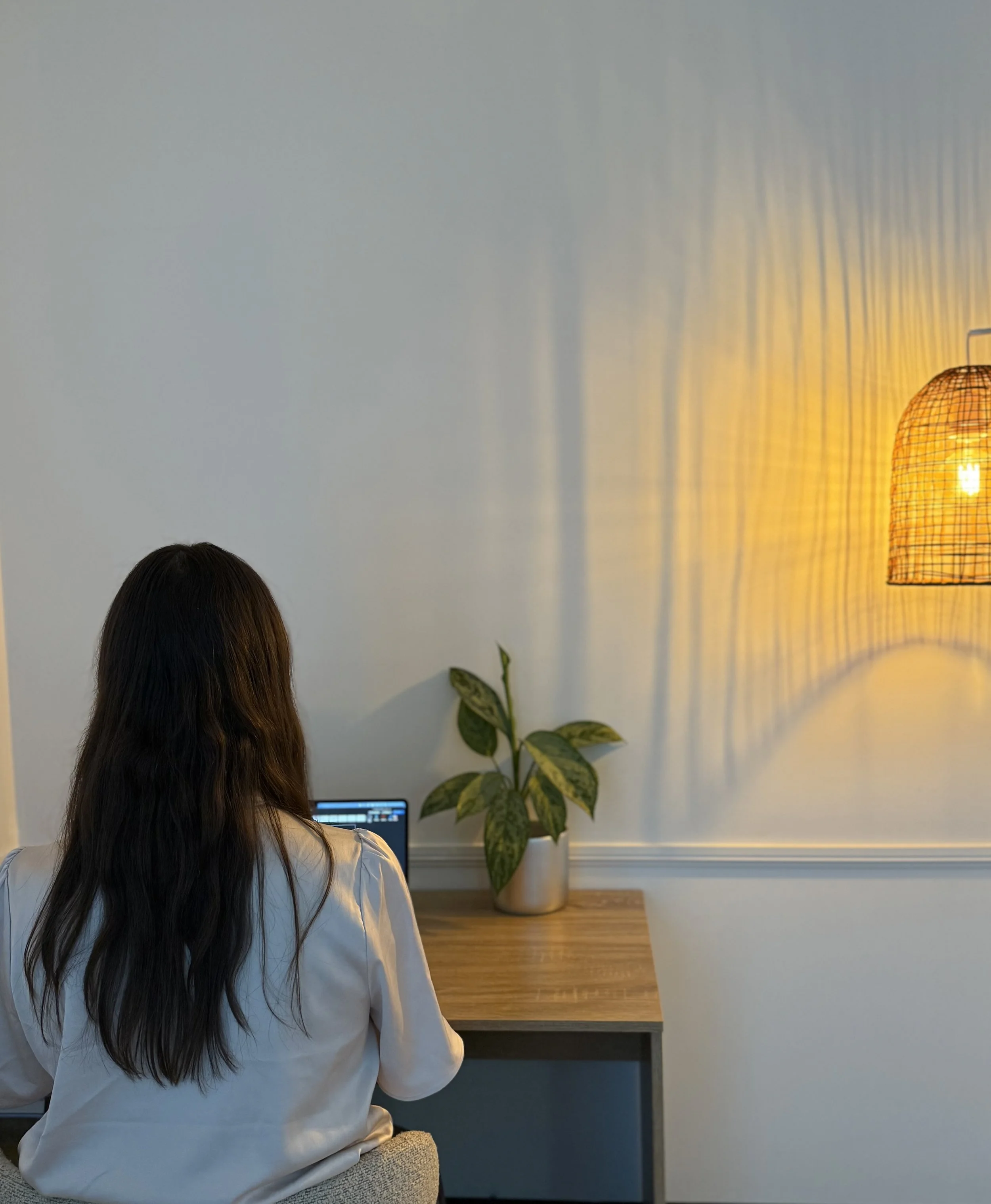 Clinical psychologist working at a desk in a calm therapy office