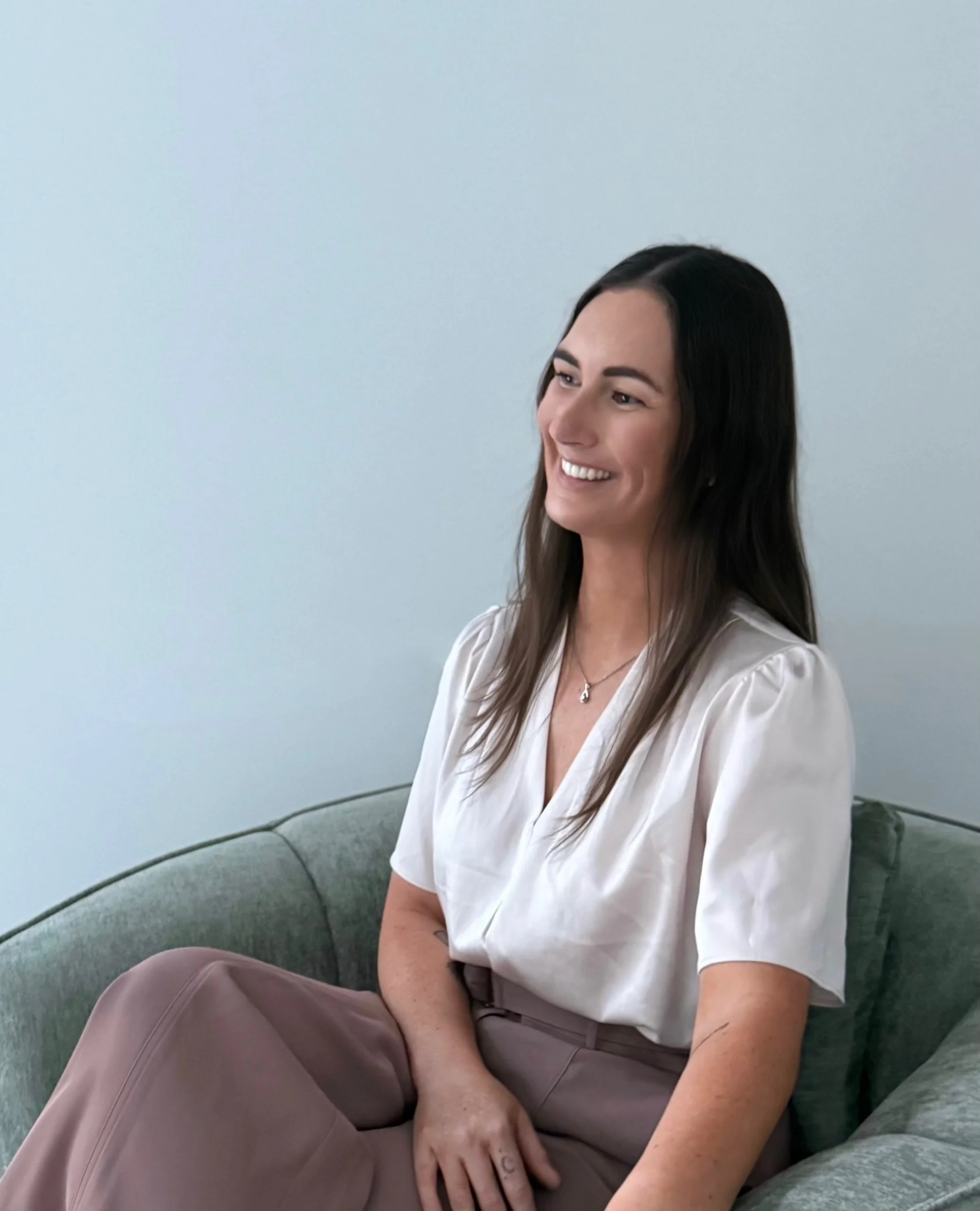 Brittany McInerney, Clinical Psychologist seated in a therapy setting