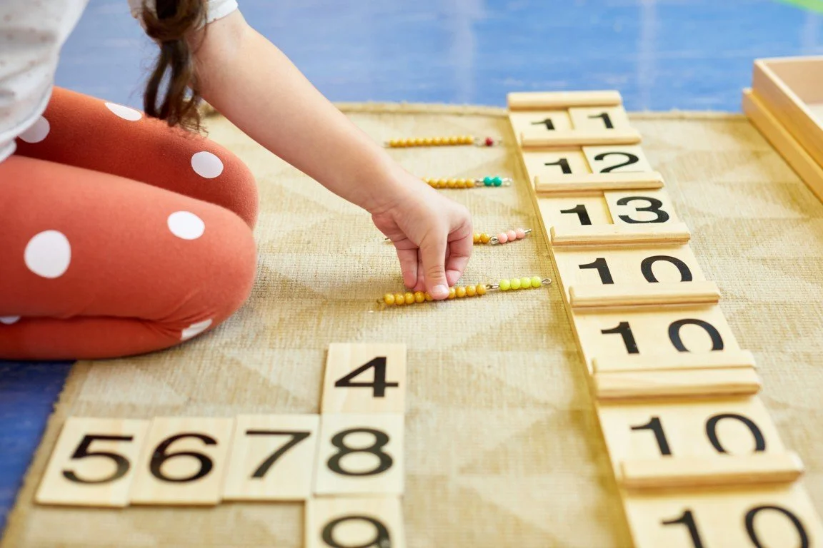 A primary school student working on a Montessori maths job
