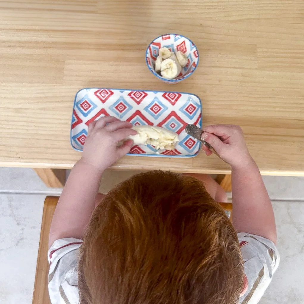 toddler-slicing-banana.jpeg