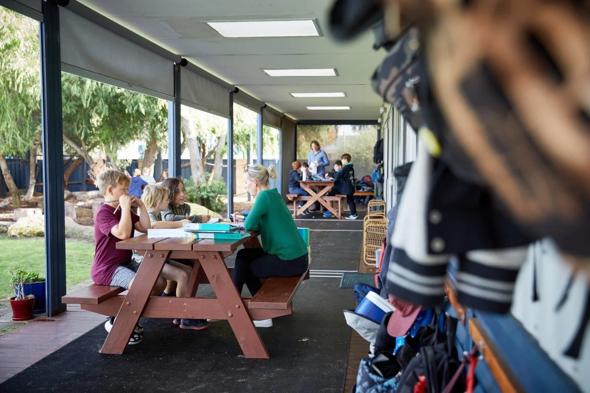 Students and a teacher working outdoors at the Rockingham Primary School campus
