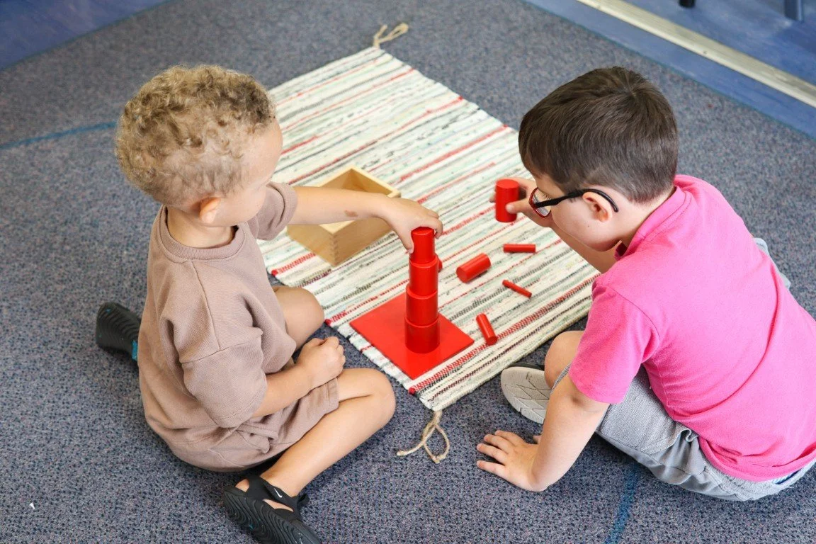 Two Montessori Children's House students working together