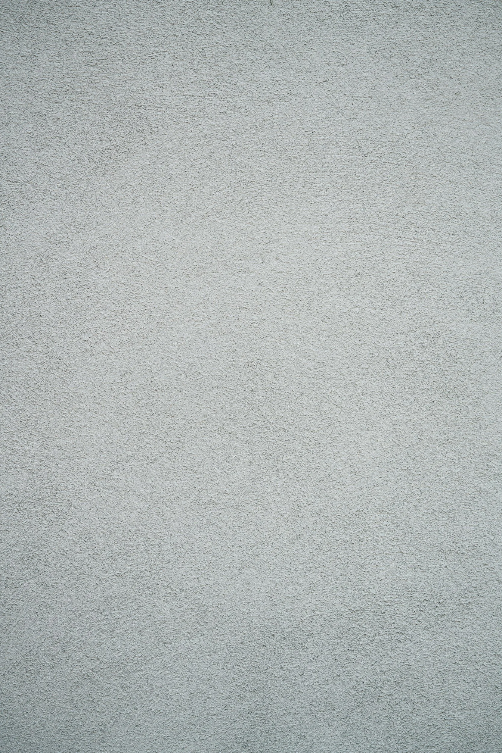 A plain, light-colored textured wall surface.