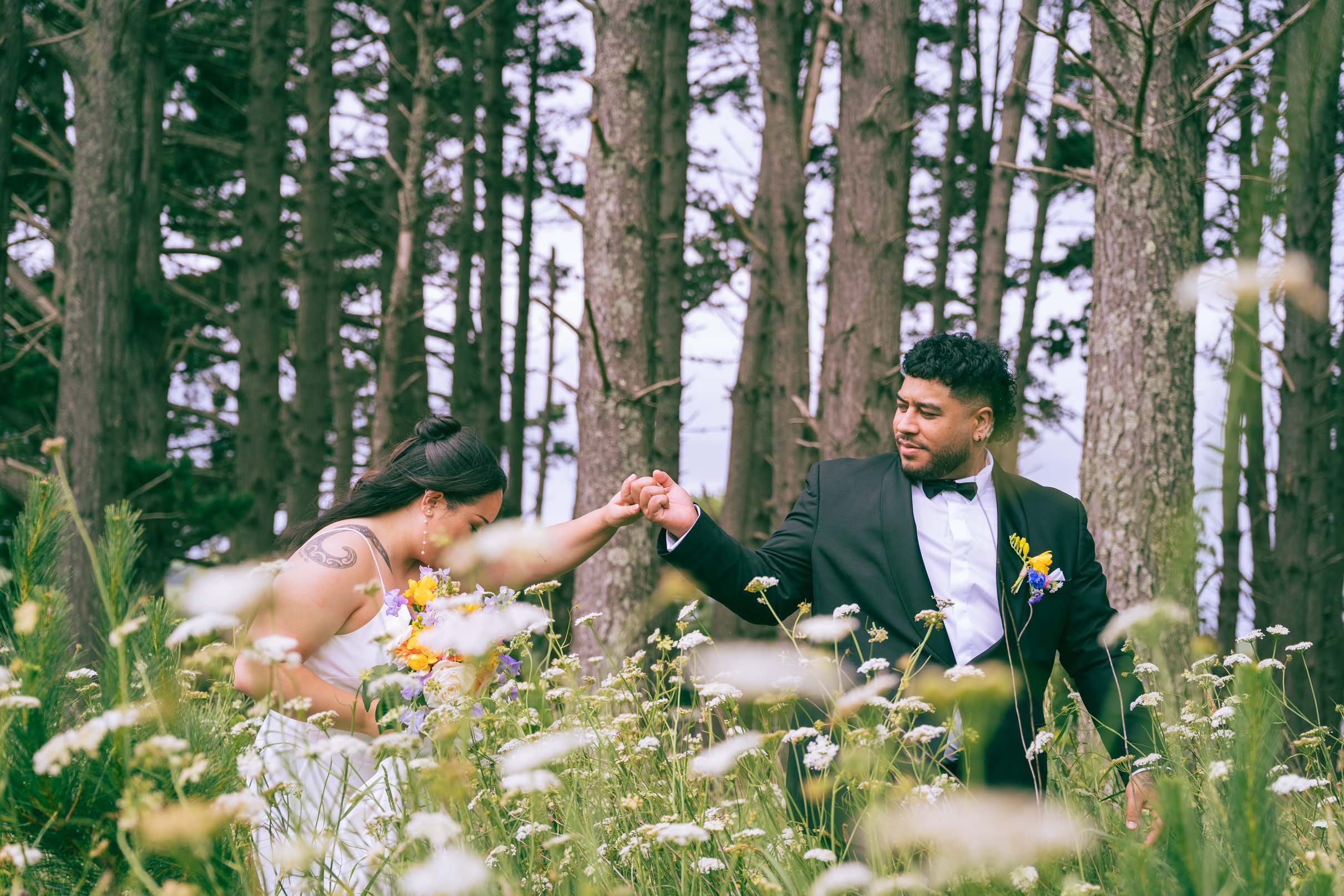 Candid wedding couples photo, walking through flower field / forest