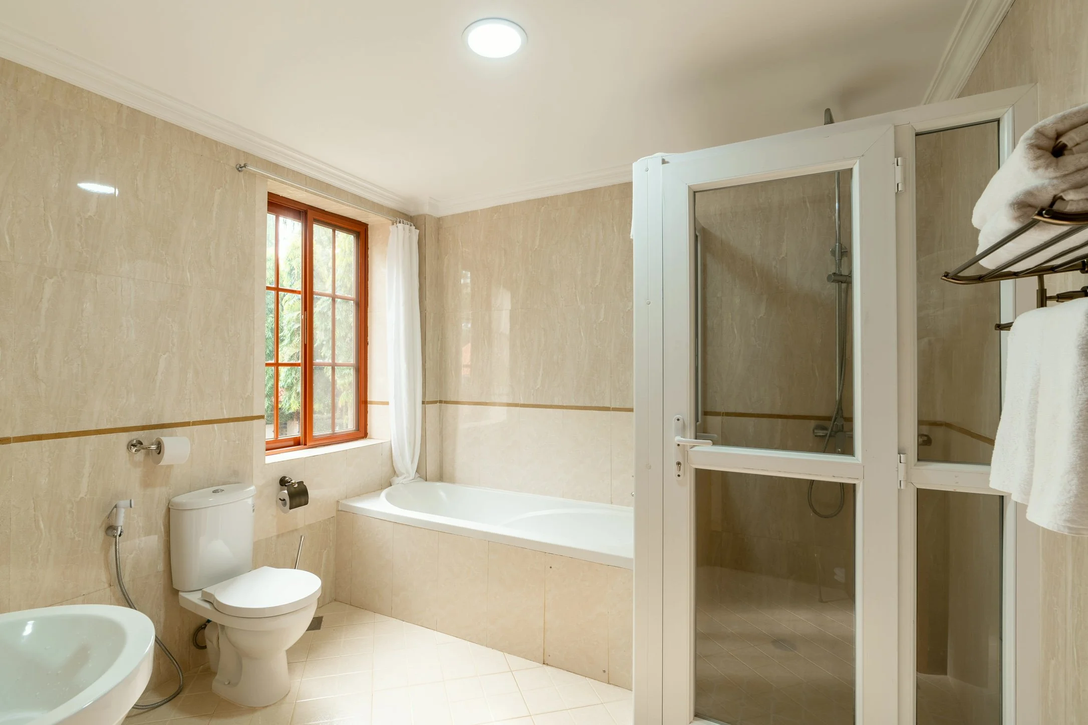 Modern bathroom with bathtub and shower at Kibo Homes Moshi