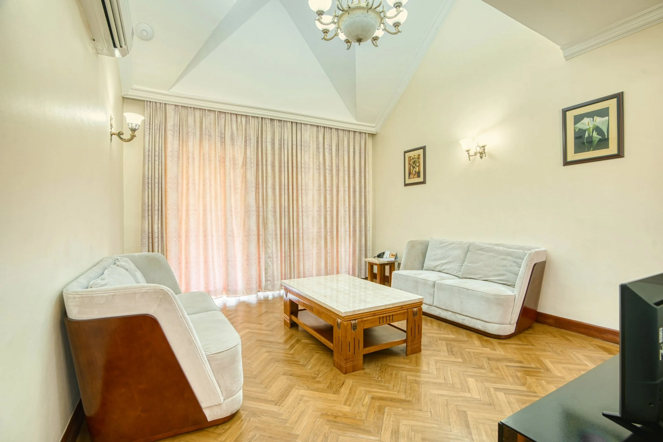 Living room with sofas and coffee table inside a Kibo Homes Moshi villa