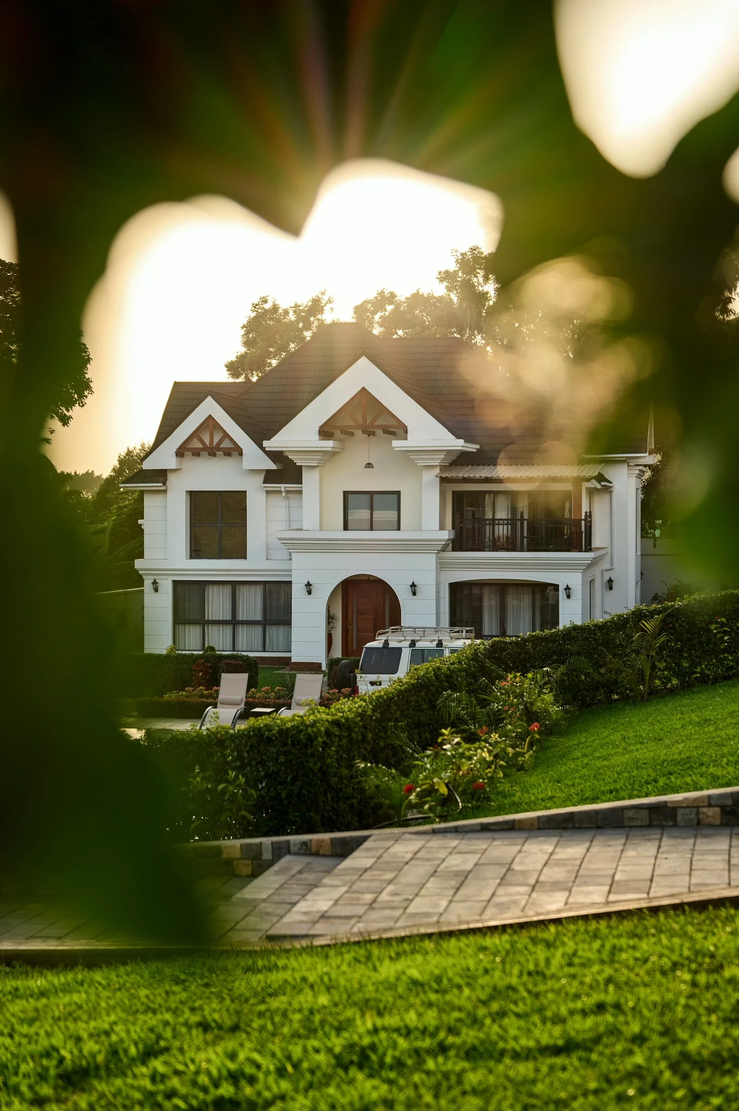 Luxury villa exterior at Kibo Homes Arusha viewed through garden greenery