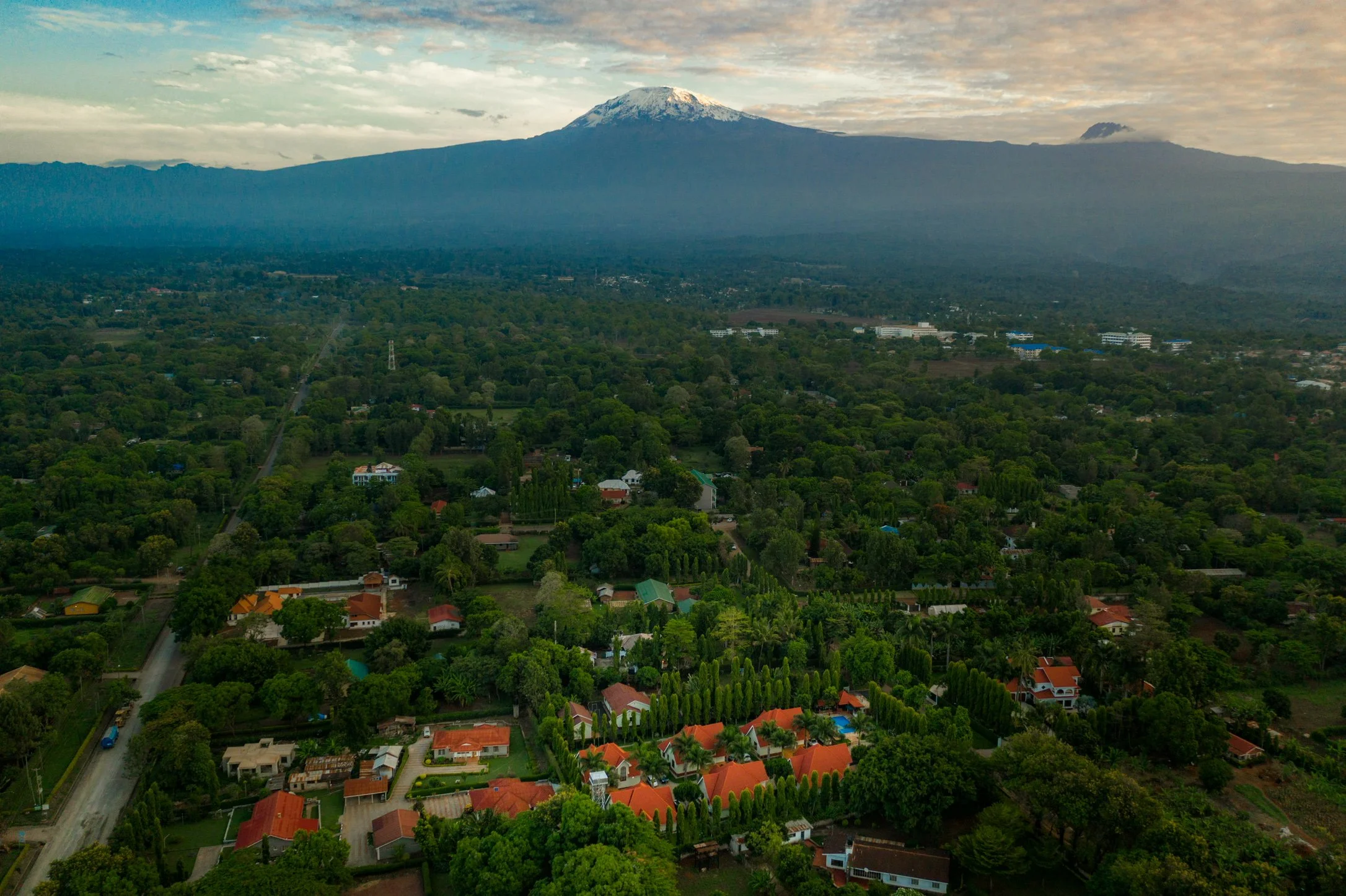 Drone view of Mount Kilimanjaro with Kibo Homes Moshi villas at the foothills