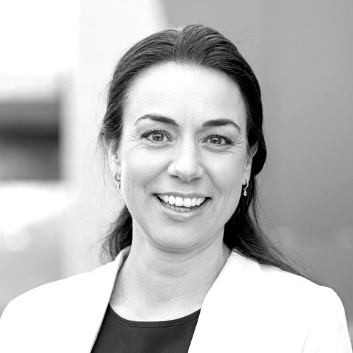 Portrett av en smilende kvinne med mørkt hår og øredobber.