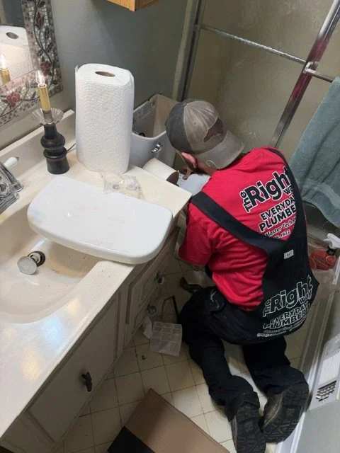 Nico repairing a toilet.