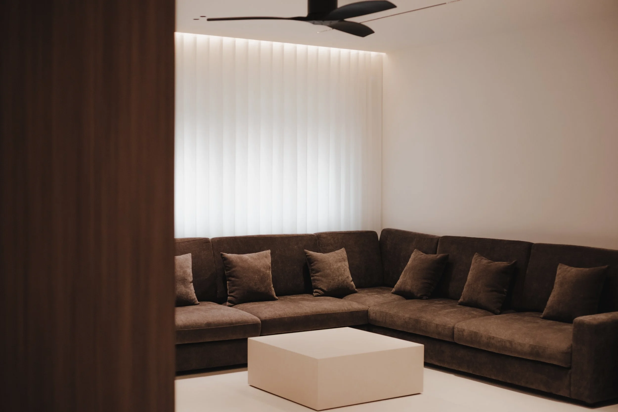 Lucent™ curtains filtering soft natural light in a modern Singapore living area with warm wood accents and luxury furniture.