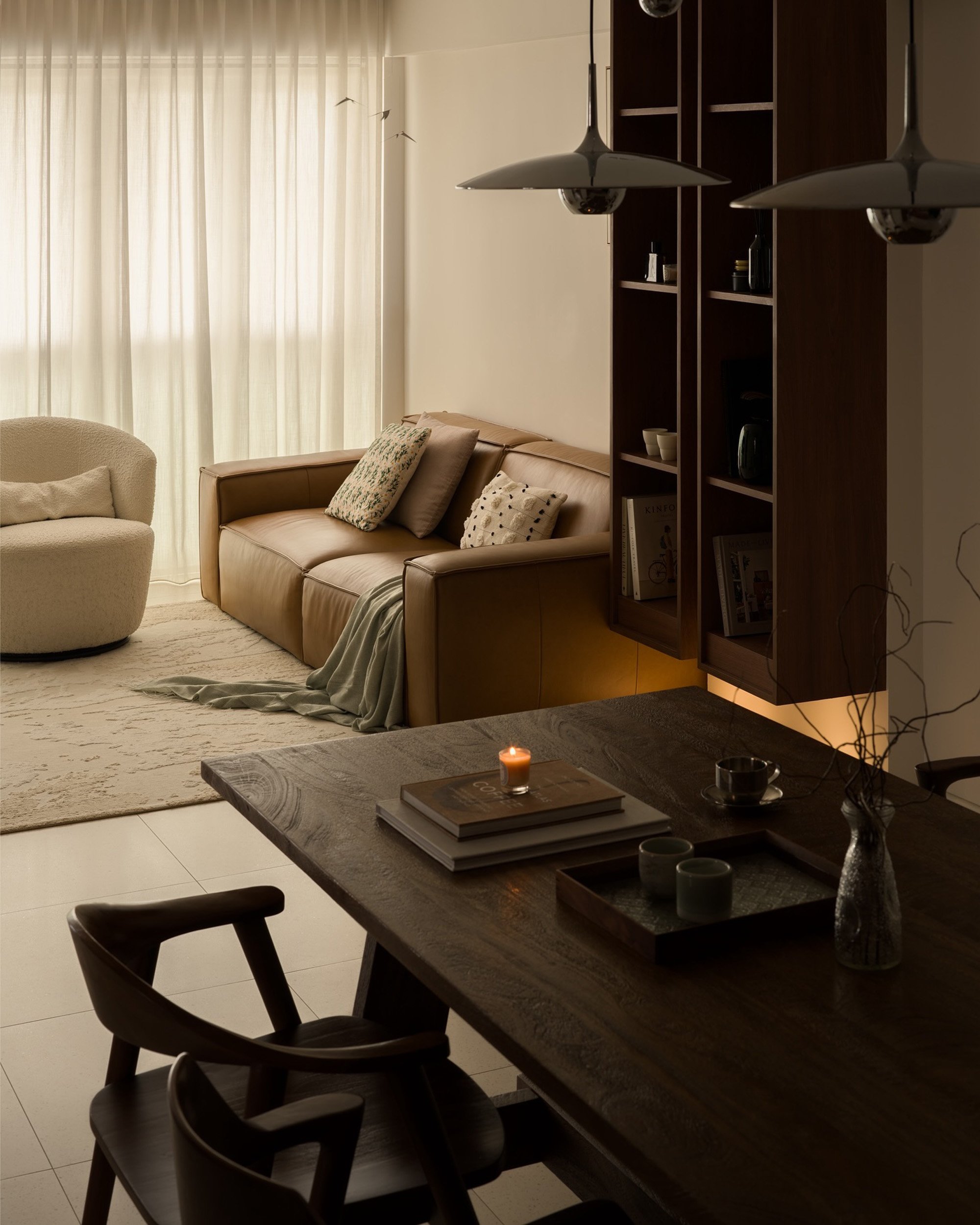 Pleated Lucent™ curtains filtering soft natural light in a warm Singapore living and dining area with wood accents and cosy furniture.